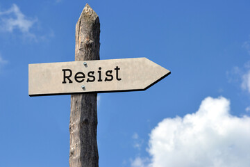 Resist - wooden signpost with one arrow, sky with clouds