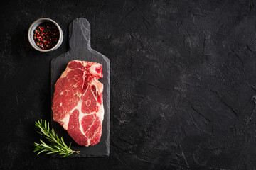 Wall Mural - Raw fillet meat pork on board with peper seasoning and green rosemary