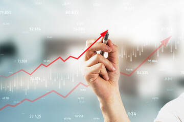 Wall Mural - Close up of hand drawing growing red business chart arrow on blurry office interior background. Finance, profit and increase concept.