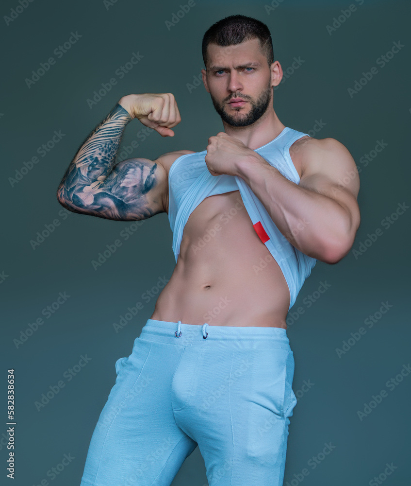 Sexy and naked muscular young man sensual posing. Sexy shirtless male