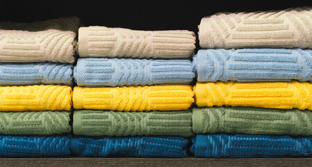 Poster - Colorful folded towels stack closeup picture, hotel service concept background