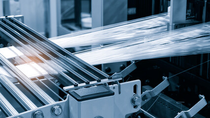 Aufkleber - Coils of synthetic textile thread thread at industrial weaving manufacturing machine