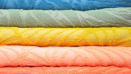 Leinwandbilder - Colorful folded towels stack closeup picture, hotel service concept