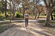 © Asier - Young caucasian woman embraces the outdoors with her running routine.