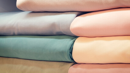 Poster - Mix colorful hanging textile, fabrics, cloths on the rack. Texture of multicolored fabrics close up.