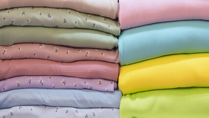 Poster - Mix colorful hanging textile, fabrics, cloths on the rack. Texture of multicolored fabrics close up.