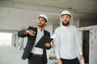 Multiethnic business team. Construction concept. Indian and Arab engineers inspect the construction.