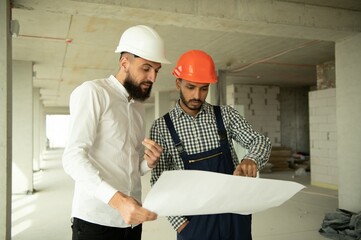 Wall Mural - Happy workers at construction site, young civil engineer manager and architects. Indian and Arabian engineers.