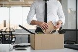 Fototapeta Tulipany - Close-up Of A Businessperson Carrying Cardboard Box During Office Meeting