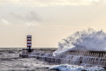 Waves Crashing On Lighthouse On Pier