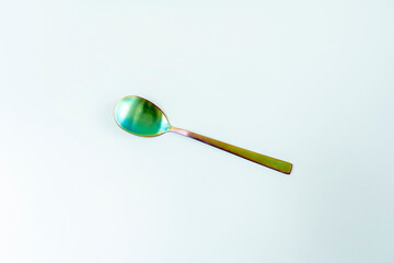 Wall Mural - A salad spoon of iridescent material