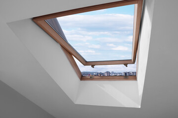 Poster - Open skylight roof window on slanted ceiling in attic room