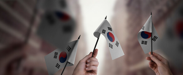 Wall Mural - A group of people holding small flags of the South Korean in their hands
