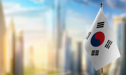 Wall Mural - Small flags of the South Korean on an abstract blurry background