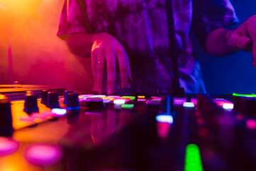 Wall Mural - Close up of DJ hands on dj console mixer during concert in the club