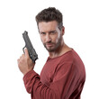 © stokkete - Cool young man holding a gun