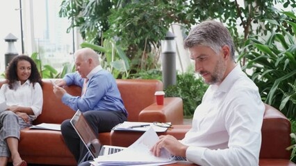 Wall Mural - business colleagues discussing financial documents before starti