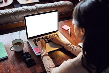 Businesswoman working on laptop at desk in loft office