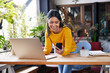 © Westend61 - Smiling businesswoman using mobile phone leaning on desk at loft office