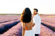 © Westend61 - Woman walking with man in lavender field
