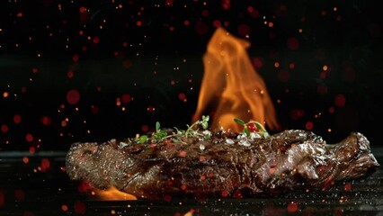 Wall Mural - Close-up of falling tasty beef steak on iron cast grate, super slow motion, filmed on high speed cinematic camera at 1000 fps.