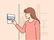 Smiling woman using smart home system on apartment wall. Female renter turn on alarm or security on panel in house. Indoor technology. Vector illustration. 