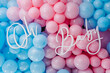 Photo zone, arch with pink and blue balloons for gender party. Boy or girl. Know gender of unborn child. Happiness of parenthood. Background, wall with text oh baby. Baby Shower party decor. Closeup.