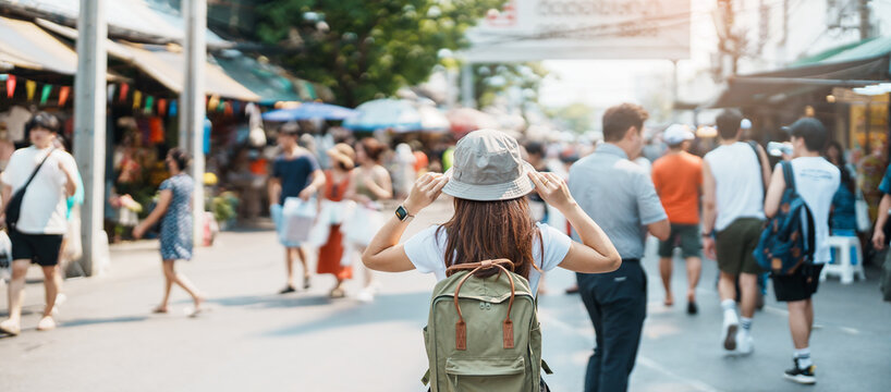 woman traveler visiting in bangkok, tourist with backpack and hat sightseeing in chatuchak weekend m