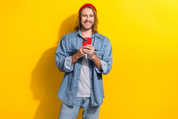 portrait of cool cheerful positive man with bob haircut wear denim jacket hold smartphone chatting i