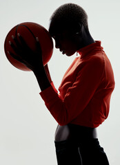 For the love of basketball. Studio shot of an attractive young woman playing basketball against a grey background.