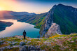 Tourist meets the sunrise on the edge of a cliff on Bovilla Lake, near Tirana city located. Spectacular spring landscape  of Albania, Europe. Beauty of nature concept background.