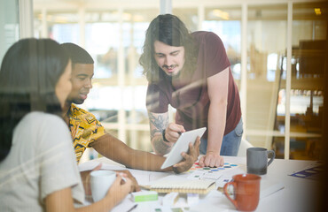 Poster - The internet is their greatest source of inspiration. a group of businesspeople working together on a digital tablet in an office.