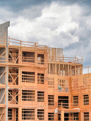 Poster - Apartment building under construction on cloudy sky background