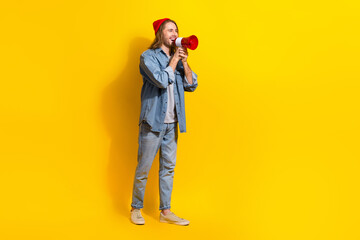 Poster - Full length photo of positive funny man wear denim screaming bullhorn emtpy space isolated yellow color background