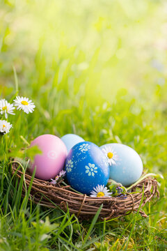 Fototapete - Nest with Easter eggs in grass on a sunny spring day - Easter decoration, background  -  Copy space
