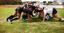 Where All Of The Power Plays Are. A Group Of Young Rugby Players In A Scrum On The Field.