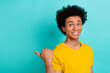 © deagreez - Photo of positive pleasant toothy beaming guy dressed yellow t-shirt indicating at sale empty space isolated on turquoise color background