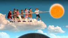 Happy Playful Little Kids, Boys And Girls Standing On Cloud And Playing Together, Pulling Sun With Rope. Contemporary Conceptual Art Collage. Surrealism. Concept Of Childhood, Dreams, Fantasy