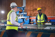 © Platoo Studio - Factory worker in safety suit, Project manager discussing with engineering man for work in metal sheet industry. Teamwork and cooperation concept.