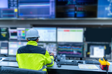 Engineer working at control room,Manager control system,Technician man monitoring program from a lot of monitor