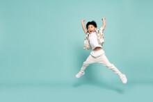Asian Little Boy In Flower Pattern Summer Outfits Jumping Isolated On Green Background, Five Years Old
