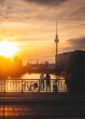 Vertical shot of two bikers on a bridge at golden hour in Berlin