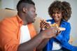 © Prostock-studio - Cheerful Black Couple Eating Pizza And Having Fun On Moving Day,