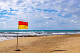 Fototapeta Do pokoju - Red and yellow Warning Sign Flag on a beach