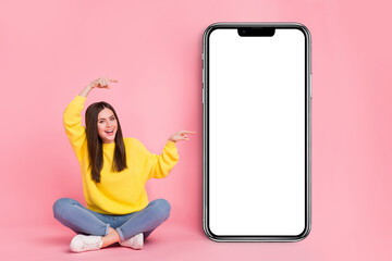 Full size photo of young pretty girl point fingers empty space select suggest direct isolated over pink color background