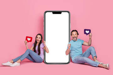 Poster - Full length photo of two overjoyed glad people raise fists celebrate hold like card isolated on pink color background