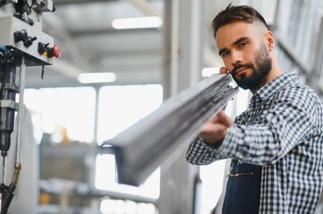 Wall Mural - Worker in uniform working on machine in PVC shop indoor