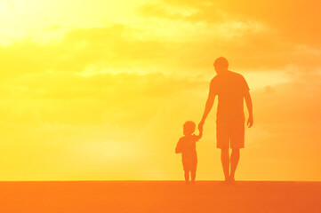 Wall Mural - Father son holding hands walking together. Parenting, and child care concept. 