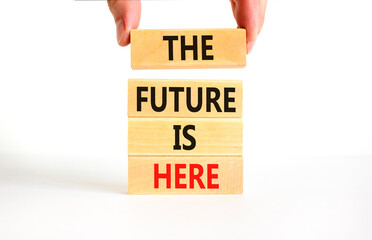 Wall Mural - The future is here symbol. Concept words The future is here on wooden block. Beautiful white table white background. Businessman hand. Motivational business the future is here concept. Copy space.