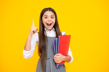 Canvas Print - Excited face. Back to school. Teenager schoolgirl with book ready to learn. School girl children on isolated yellow studio background. Amazed expression, cheerful and glad.